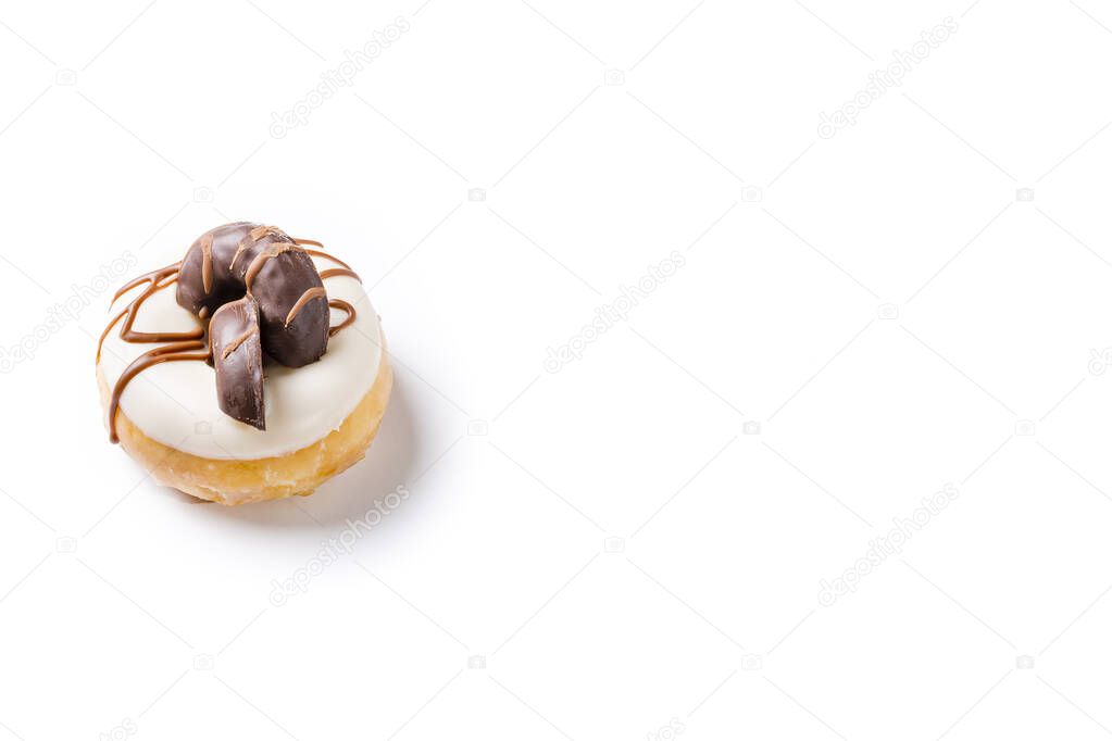 Photograph of a white chocolate donuts with dark chocolate cookies on a white background.The photo is taken in horizontal format.