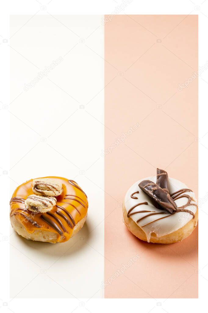 Photograph of two donuts decorated with cookies and drawn with chocolate.The photo is taken in portrait format and has a white frame around it.