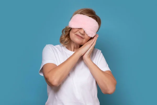 stock image Mature woman with sleeping mask on her eyes. Passenger wanting to have a nap