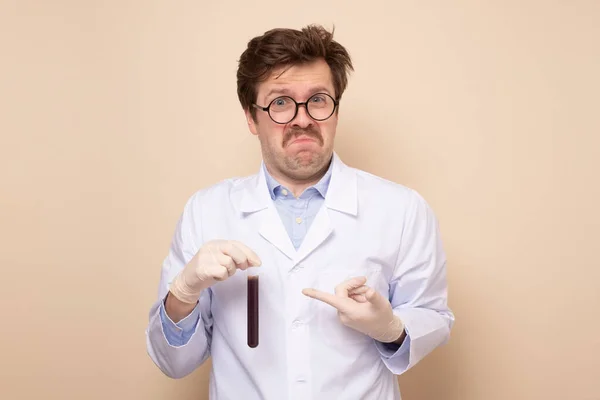 Doctor wetenschappelijk onderzoek assistent in een medische jas holding tube met vloeistof. — Stockfoto