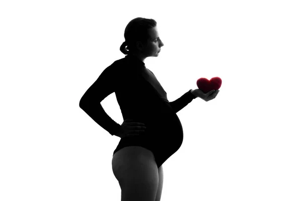 Pregnant woman with heart symbol isolated over white background — Stock Photo, Image