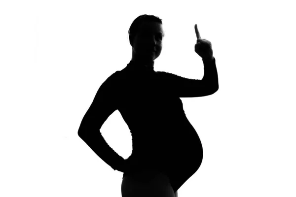 Pregnant woman raising index finger up giving advice or pointing on important information. — Stock Fotó