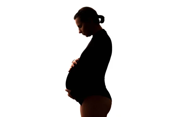 Pregnant caucasian woman looking on her belly. — Stock Photo, Image