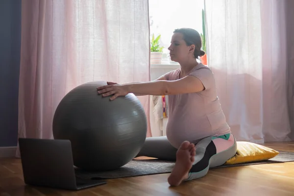 Pregnant woman in sportswear, doing yoga, pilates training, Wide Angle Seated Forward Bend pose, Upavishtha Konasana — Stock Photo, Image