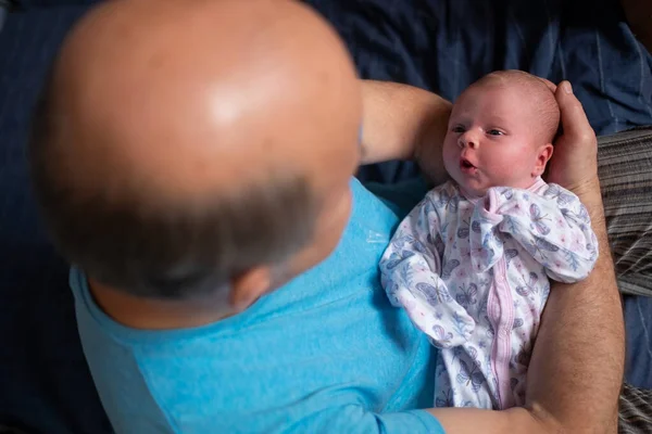 Grandfather holding a beautiful newborn baby girl — Stock Photo, Image