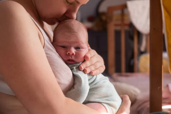 Caucasian mother holdin her newborn baby girl spending time together — Stock Photo, Image