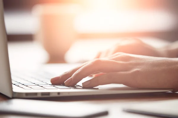 hands typing on keyboard