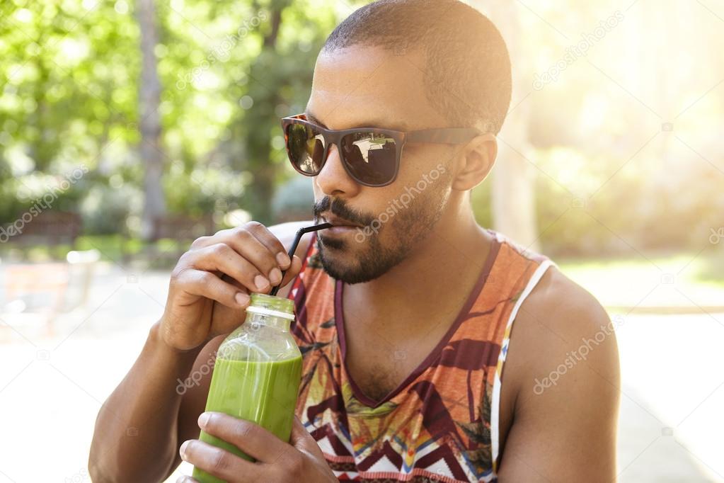 guy drinking fresh green smoothie — Stock Photo © avemario #119768096