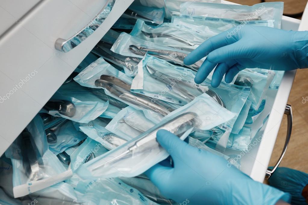 Medical laboratory technician holding a set of sterile disposable