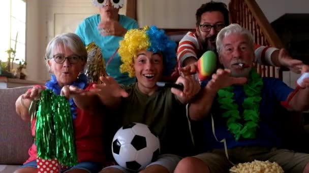 穿着滑稽服装的酷家庭观看足球比赛和支持球队 — 图库视频影像