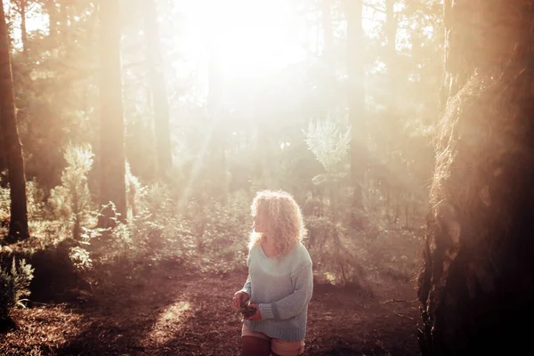 女人独自在森林里散步 享受着自由和自然的树木 背景是夕阳西下 — 图库照片
