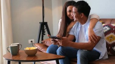 Mutlu çift evde telefonuyla hayatın tadını çıkarıyor.