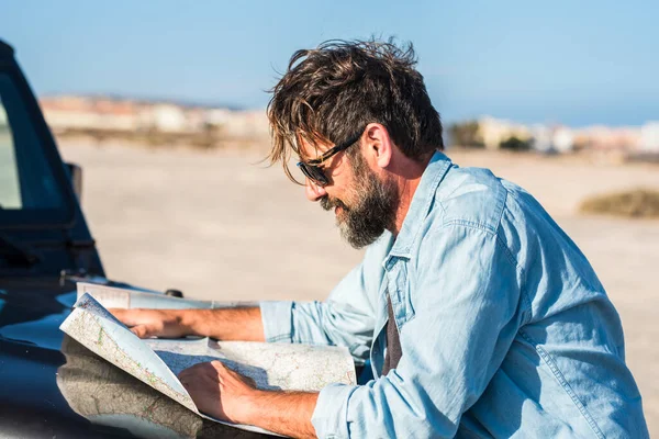 Man Looking Paper Road Trip Map Standing Car Blue Sky — Stock Photo, Image