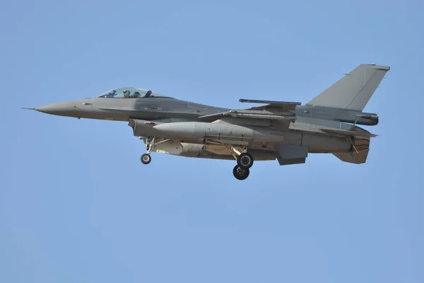 Fighter plane landing with landing gear lowered