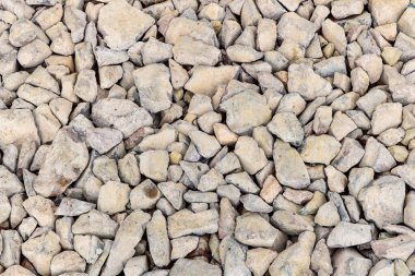 Various irregularly shaped, compacted stones as the basis for future asphalt pavement