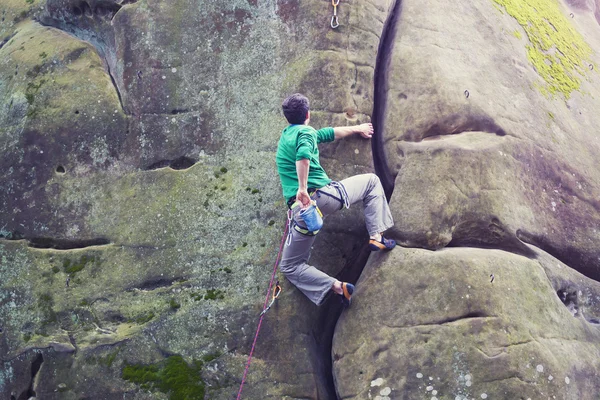 Un escalador sube a la montaña . — Foto de Stock