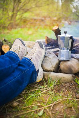 Ateşin yanında oturan insanlar.