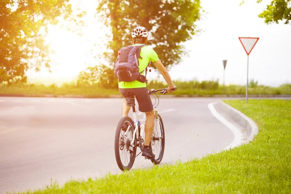 A man on a Bicycle with a backpack. — Stock Photo, Image