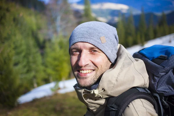 Portrait of mountaineer with mountains in the background. Stock Photo