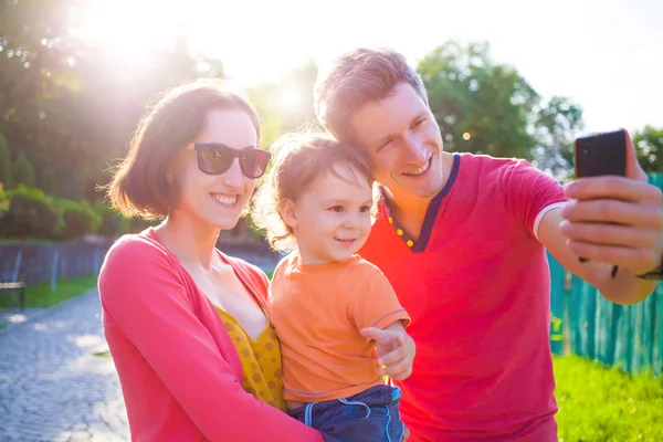 Junge und glückliche Familie macht ein Selfie. — Stockfoto