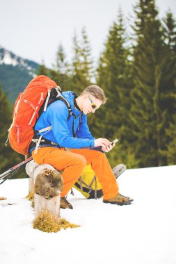 Uzun yürüyüşe çıkan kimse ile bir yürüyüş sırasında dinlenme sırt çantası.