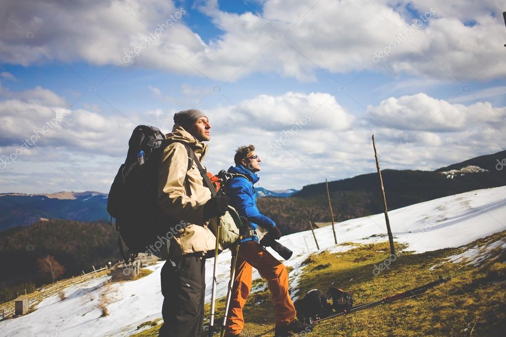 Two other tourists with backpacks and cameras.