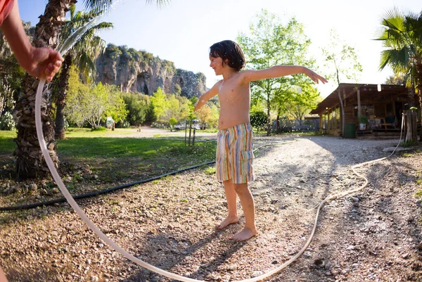 Boy Drenched Water Hot Sunny Day Mother Sprays Child Hose — Stock Photo, Image