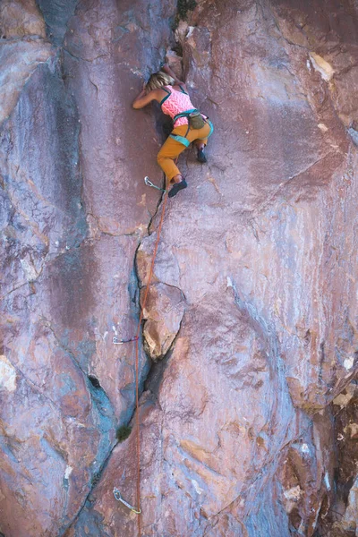 A strong climber climbs a rock, a woman trains strength and endurance, overcoming the fear of heights, a girl trains on Turkish rocks.