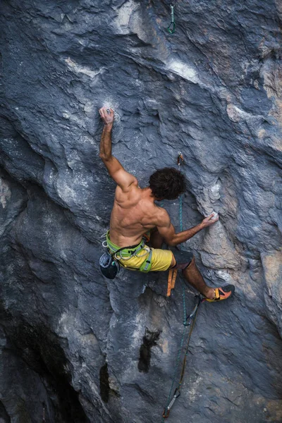 A strong man climbs a rock, Strong back muscles, Rock climbing in Turkey, Training endurance and strength, man in extreme sport, Rock climber is training in nature.