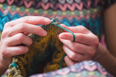 Kadın örgü örer. ev yünü kıyafetler. Boş zamanlarında, kız bir hobiyle meşgul oluyor..