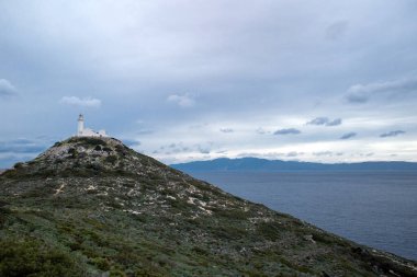 Datca 'daki antik deniz feneri, Türkiye kıyıları, deniz arka planında deniz feneri ve bulutlu gökyüzü, Türkiye manzarası