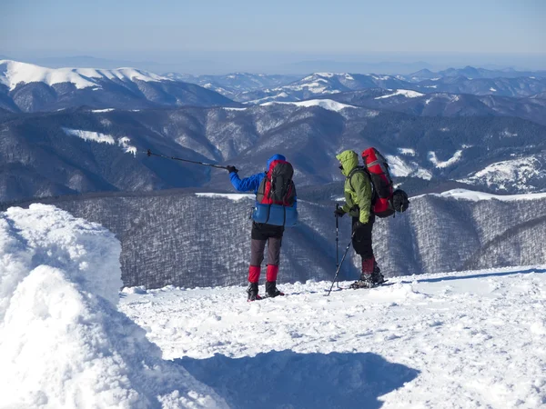 A man shows the way in the mountains. — Stock Photo, Image