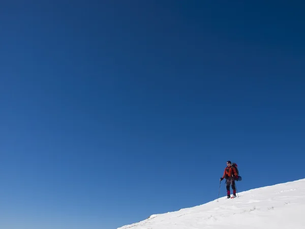 Un homme en raquettes est dans les montagnes . — Photo