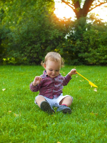 Liten pojke leker med en paddel. — Stockfoto