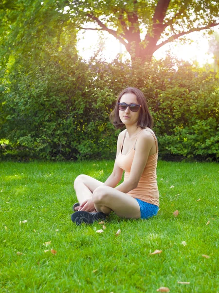 Jeune fille assise sur l'herbe. — Photo