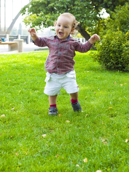 An infant learns to walk. Royalty Free Stock Photos