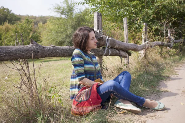 Girl sitting near the road. — Stock Photo, Image