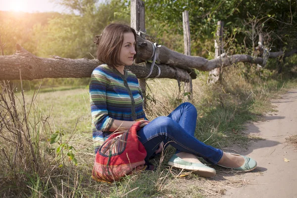 Girl sitting near the road. — Stock Photo, Image