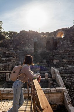 Harabeler arasında gezinen şık bir turistin portresi. Eski taş kalıntıları yakınında bir turist. Seyahat eden bir kız.