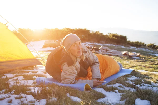 The girl with the phone lying in a sleeping bag. — Stock Photo, Image