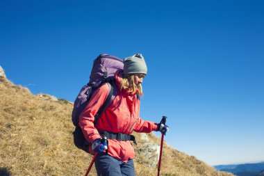 Bir kadın yokuş aşağı yürüyor.