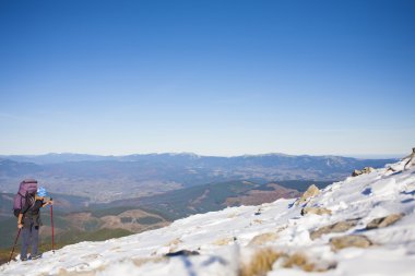 Kız dağın zirvesine tırmanıyor.