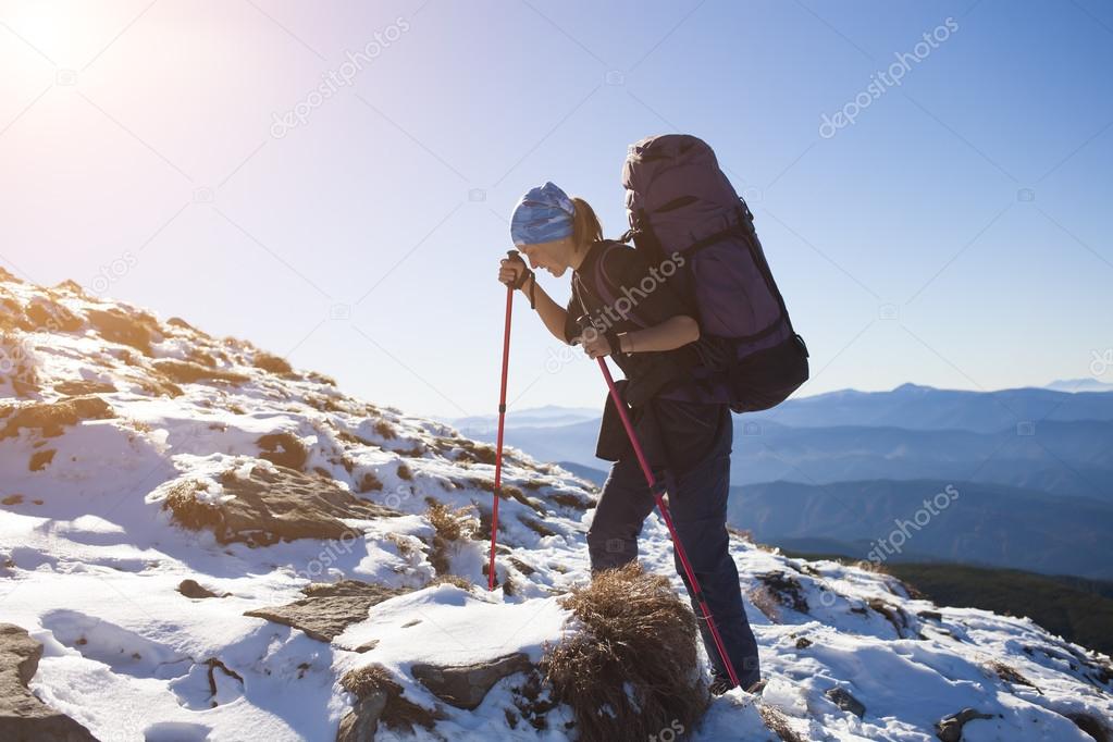 The girl climbs the mountain.
