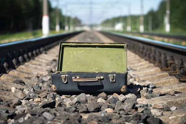 Vacía maleta vieja abierta en las traviesas del ferrocarril en la mañana de verano — Foto de Stock
