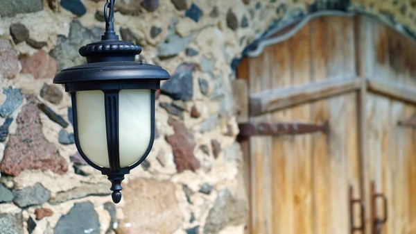 Vintage lantern hanging on the wall of old stone house — Stock Photo, Image