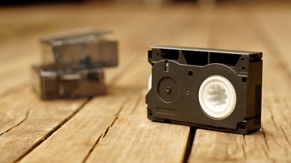 Старая компактная видеокассета на деревянном полу

