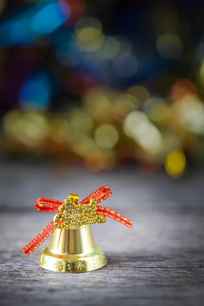 Christmas gold bell with bokeh background. — Stock Photo, Image