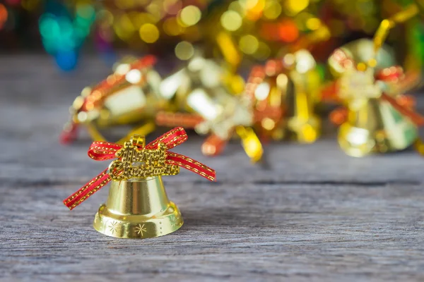 Christmas gold bells with bokeh decorations background. — Stock Photo, Image