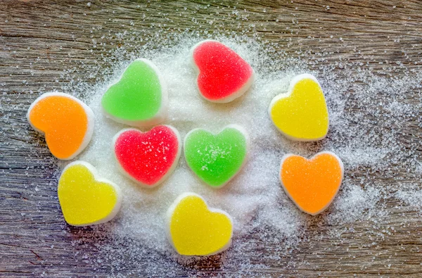 Jalea dulce, fruta sabor, postre de caramelo colorido sobre fondo de madera . —  Fotos de Stock