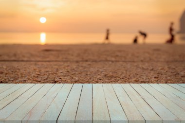 Ahşap masa ve kum plaj arka plan üzerinde gündoğumu ve günbatımı görünümü boş Üstten Görünüm.